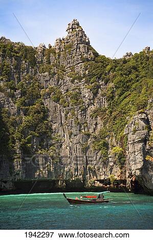 Stock Photo - Longboat Off The Coast Of Ko Phi Phi Lei; Phuket Thailand. Fotosearch