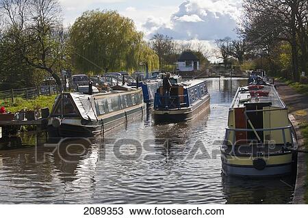 Stock Image - Longboats In The Canal; Stratford-Upon-Avon, England. Fotosearch