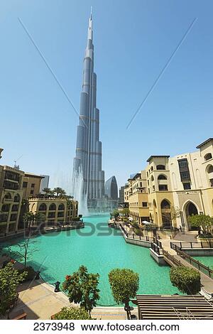 Stock Photo - Looking across large artificial lake to fountain display beneath the Burj Khalifa; Dubai, United Arab Emirates. Fotosearch