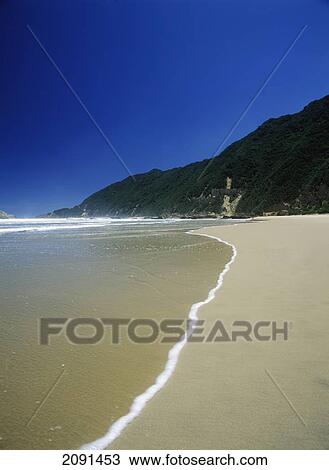 Stock Image - Looking Along Deserted Beach On The Garden Route Near The Town Of Wilderness, South Africa.. Fotosearch