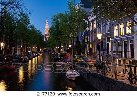 Looking Along Small Canal With The Spire Of The Zuiderkerk Church At The End At Duskamsterdam, Holland. View Large Photo Image Stock Image - Looking Along Small Canal With The Spire Of The Zuiderkerk Church At The End At Duskamsterdam, Holland.. Fotosearch