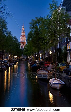 Looking along small canal with the spire of the Zuiderkerk church at the end at dusk; Amsterdam, Holland View Large Photo Image Stock Photography - Looking along small canal with the spire of the Zuiderkerk church at the end at dusk; Amsterdam, Holland. Fotosearch