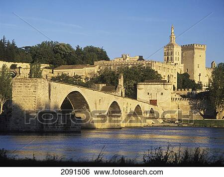 Stock Photograph - Looking Along The Pont D'avignon Or Pont St Benezet Towards The Palais Des Papes (Palace Of The Popes) And The Cathedrale Notre-Dame-Des-Doms In The Early Evening, Avignon, France.. Fotosearch