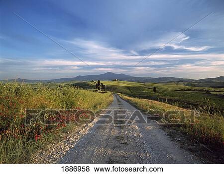 Stock Photo - Looking Down Dirt Road To Farmhouse On Hilltop. Fotosearch