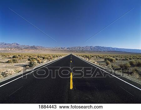 Stock Image - Looking Down Long Straight Road Near Stovepipe Wells. Fotosearch