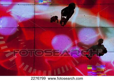 Stock Photo - Looking down on children with adults on illuminated LED floor, Dubai Mall shopping centre; Dubai, United Arab Emirates. Fotosearch