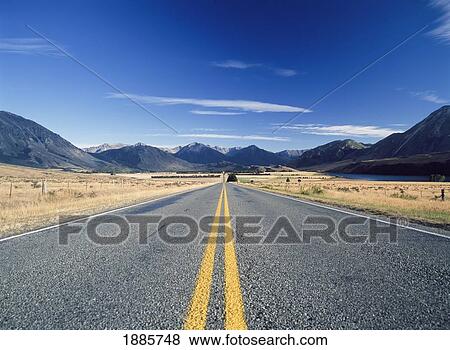 Stock Photo - Looking Down Yellow Lines On Long Straight Road. Fotosearch