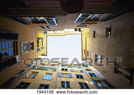 Stock Photograph - Looking Straight Up Between Buildings; Genoa Liguria Italy. Fotosearch