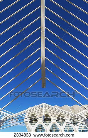 Stock Image - Looking Through Detail Of Umbracle To El Museu De Les Ciencies Principe Felipe In Ciudad De Las Artes Y Las Ciencias (City Of Arts And Sciences); Valencia, Spain. Fotosearch