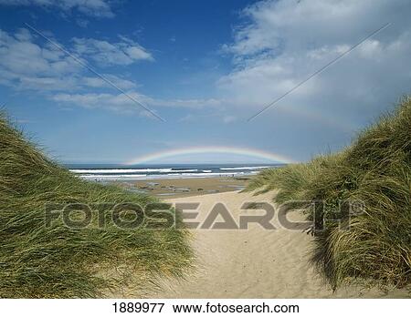 Stock Photo - Looking Through Gap In Dunes To Double Rainbow. Fotosearch