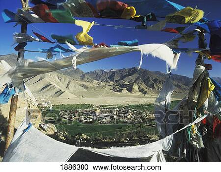 Stock Image - Looking Through Prayer Flags At Dawn To Samye Monastery. Fotosearch