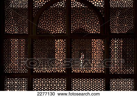 Looking through stone lattice wall to man praying in the Jami Masjid; Fatehpur Sikri, Agra, India View Large Photo Image Stock Image - Looking through stone lattice wall to man praying in the Jami Masjid; Fatehpur Sikri, Agra, India. Fotosearch