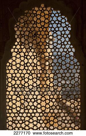 Looking through stone lattice window to the walls of Amber Fort; Amer, Jaipur, India View Large Photo Image Stock Image - Looking through stone lattice window to the walls of Amber Fort; Amer, Jaipur, India. Fotosearch