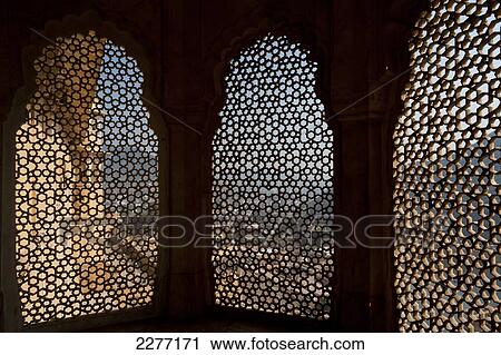 Looking through stone lattice window to the walls of Amber Fort; Amer, Jaipur, India View Large Photo Image Stock Image - Looking through stone lattice window to the walls of Amber Fort; Amer, Jaipur, India. Fotosearch