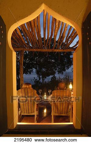 Looking Through Window Of Room To Couple Having Drinks At Dusk, Jakes, Treasure Beach, Jamaica. View Large Photo Image Stock Image - Looking Through Window Of Room To Couple Having Drinks At Dusk, Jakes, Treasure Beach, Jamaica.. Fotosearch