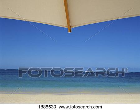 Stock Image - Looking Towards Ocean Through White Beach Umbrella. Fotosearch