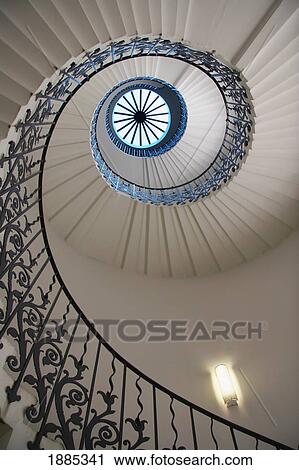 Stock Image - Looking Up At A Spiral Staircase. Fotosearch
