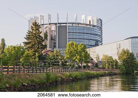 Stock Image - Louise Weiss Building And The European Parliament On The Banks Of The Ill River, Strasbourg, France. Fotosearch