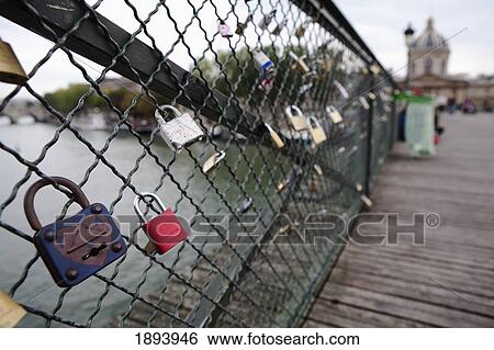 Stock Photograph - Love Locks Attached To Ponts Des Arts Bridge Fencing; Paris, France. Fotosearch
