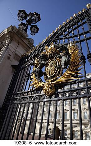Stock Photograph - Low angle close-up on Buckingham Palace Gates featuring the Royal Coat of Arms. London, England, London, England.. Fotosearch