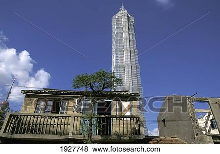 Stock Photo - Low Angle Of Jin Mao Tower With Little Huts, Pudong New Area. Fotosearch