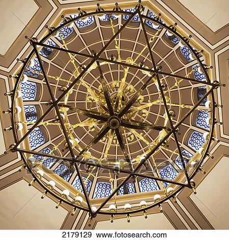 Stock Photo - Low Angle View Of A Dome Ceiling Through A Hanging Chandelier In A Star Of David Shape In The Neve Salom Synagogue; Istanbul Turkey. Fotosearch