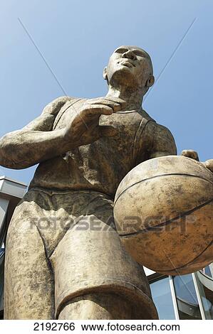 Stock Photograph - Low Angle View Of A Statue Of A Basketball Player; Orlando Florida United States Of America. Fotosearch