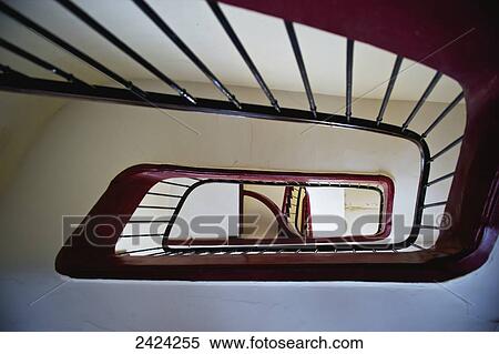 Stock Photography - Low angle view of a wooden handrail and railing inside a building, Marais district; Paris, France. Fotosearch
