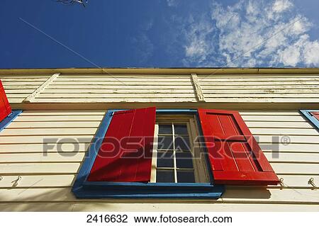 Low angle view of a yellow building with bright red shutters over a window; Carlisle Bay, Antigua View Large Photo Image Stock Image - Low angle view of a yellow building with bright red shutters over a window; Carlisle Bay, Antigua. Fotosearch