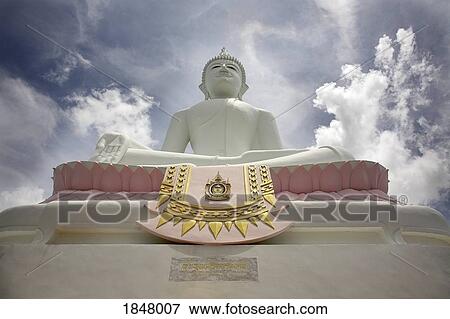 Stock Photo - Low Angle View Of Buddha And Temple; Phra Buddhasurintaramongkol, Isan, Thailand. Fotosearch