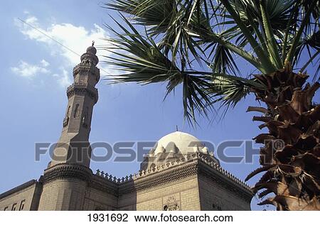 Low Angle View Of Minaret And Dome Of Sultan Hassan Mosque With Palm Tree, Cairo, Egypt; Cairo, Egypt View Large Photo Image Stock Image - Low Angle View Of Minaret And Dome Of Sultan Hassan Mosque With Palm Tree, Cairo, Egypt; Cairo, Egypt. Fotosearch