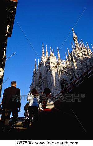 Stock Photo - Low Angle View Of Pedestrians And Duomo. Fotosearch