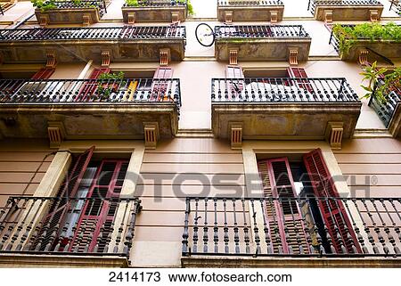 Stock Image - Low angle view of shutter doors on balconies; Barcelona, Spain. Fotosearch