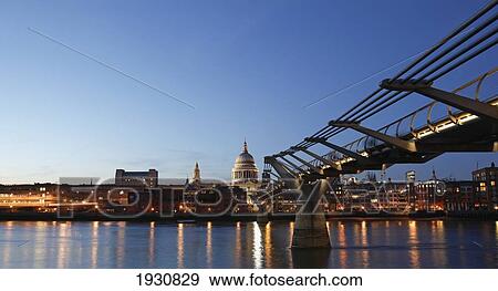Stock Photo - Low angle view of St Paul's Cathedral and the Millennium Bridge, River Thames, London, England, UK.. Fotosearch