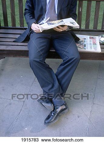 Low Section Of Businessman Sitting On Bench Reading Newspaper View Large Photo Image Stock Image - Low Section Of Businessman Sitting On Bench Reading Newspaper. Fotosearch