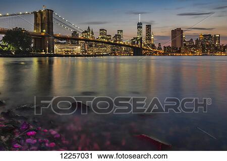 Lower Manhattan at twilight with the Brooklyn Bridge, Brooklyn Bridge Park; Brooklyn, New York, United States of America View Large Photo Image Stock Image - Lower Manhattan at twilight with the Brooklyn Bridge, Brooklyn Bridge Park; Brooklyn, New York, United States of America. Fotosearch