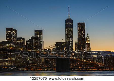 Stock Photography - Lower Manhattan at twilight with the Brooklyn Bridge; New York City, New York, United States of America. Fotosearch