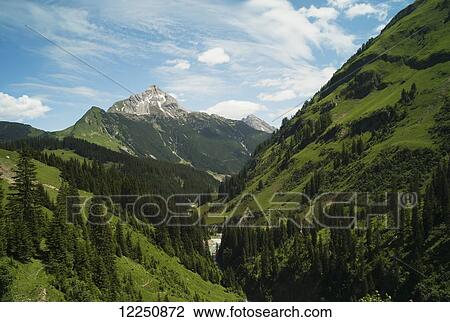 Stock Image - Lush valley and mountain peak; Austria. Fotosearch