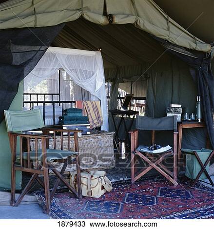 Stock Image - Luxury Tent With Folding Chairs And Canopy Be. Fotosearch
