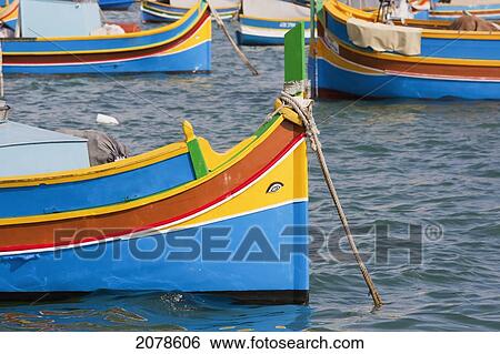Stock Photograph - Luzzu, A Traditional Maltese Fishing Boat In The Harbour, Marsaxlokk, Malta. Fotosearch