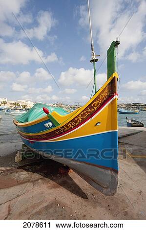 Stock Image - Luzzus, A Traditional Maltese Fishing Boat On The Beach, Marsaxlokk, Malta. Fotosearch