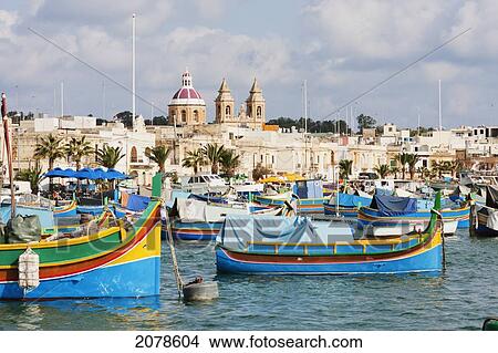 Luzzus, Traditional Maltese Fishing Boats In The Harbour, Marsaxlokk, Malta View Large Photo Image Picture - Luzzus, Traditional Maltese Fishing Boats In The Harbour, Marsaxlokk, Malta. Fotosearch