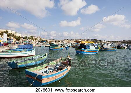 Luzzus, Traditional Maltese Fishing Boats In The Harbour, Marsaxlokk, Malta View Large Photo Image Stock Image - Luzzus, Traditional Maltese Fishing Boats In The Harbour, Marsaxlokk, Malta. Fotosearch