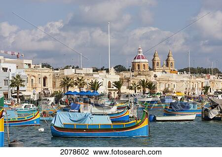 Luzzus, Traditional Maltese Fishing Boats In The Harbour, Marsaxlokk, Malta View Large Photo Image Stock Image - Luzzus, Traditional Maltese Fishing Boats In The Harbour, Marsaxlokk, Malta. Fotosearch