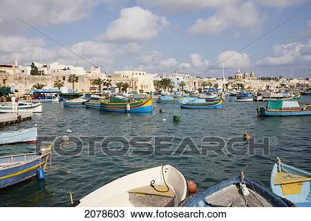 Luzzus, Traditional Maltese Fishing Boats In The Harbour, Marsaxlokk, Malta View Large Photo Image Stock Image - Luzzus, Traditional Maltese Fishing Boats In The Harbour, Marsaxlokk, Malta. Fotosearch