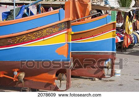 Stock Photo - Luzzus, Traditional Maltese Fishing Boats On The Beach, Marsaxlokk, Malta. Fotosearch