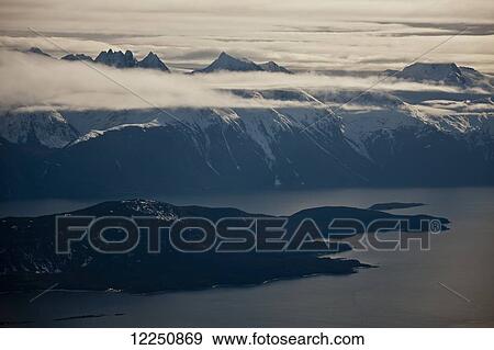 Stock Photo - Lynn Canal and mountain peaks above the clouds; Haines, Alaska, United States of America. Fotosearch