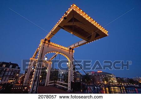 Stock Photo - Magere Brug At Night, Amsterdam, Netherlands. Fotosearch