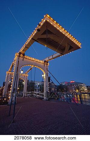 Stock Photo - Magere Brug At Night, Amsterdam, Netherlands. Fotosearch