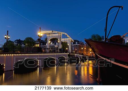 Stock Photo - Magere Brug Or Skinny Bridge At Dusk, Amsterdam, Holland.. Fotosearch